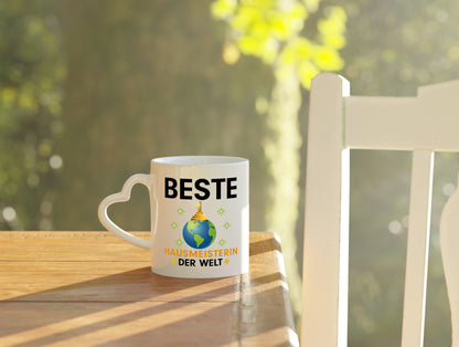 Welt Beste Hausmeisterin | Hauswart - Herzhenkel Tasse - Kaffeetasse / Geschenk / Familie